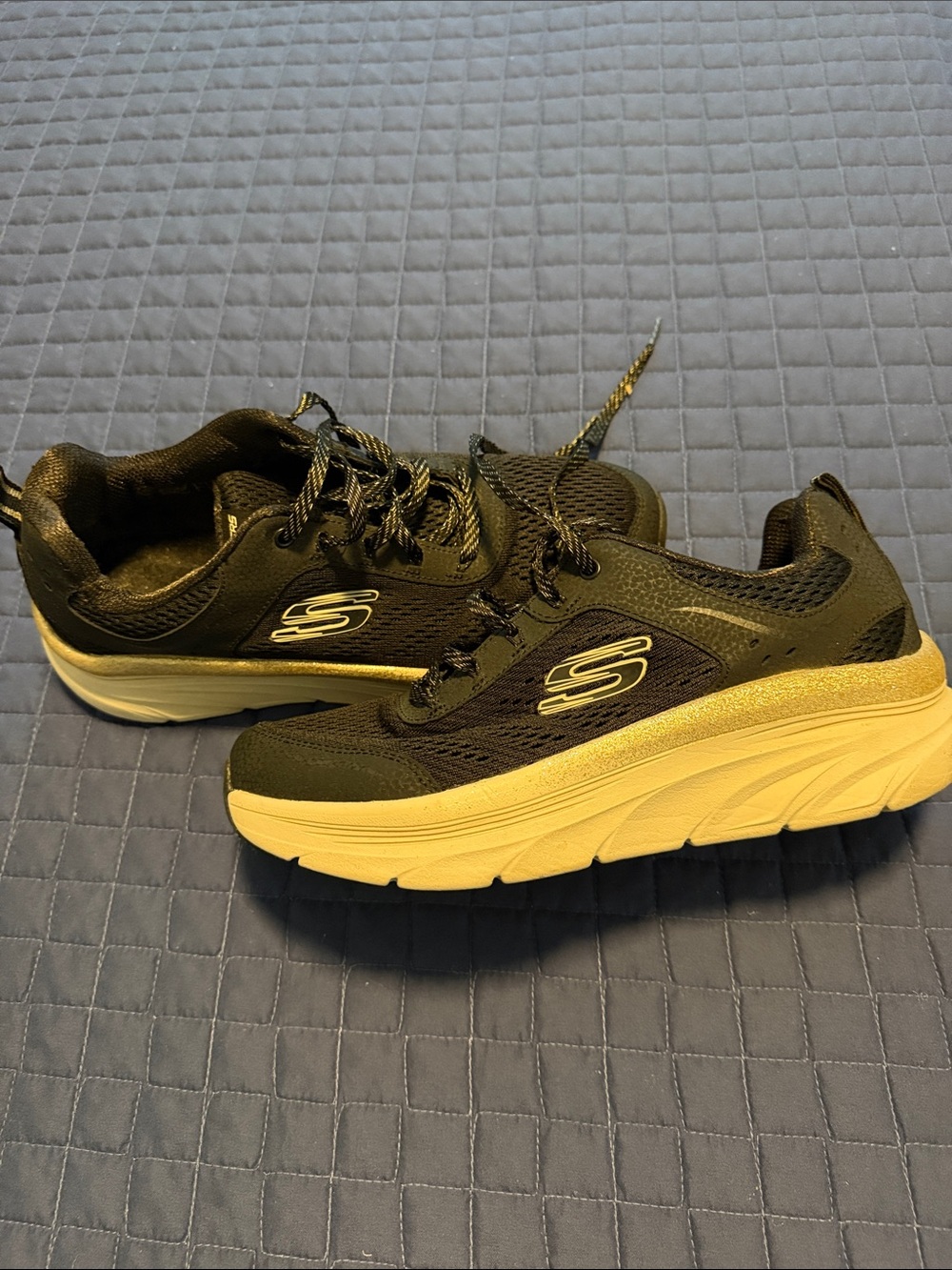 Skechers Women’s  Black/Gold sneakers.
Great walking sneakers.